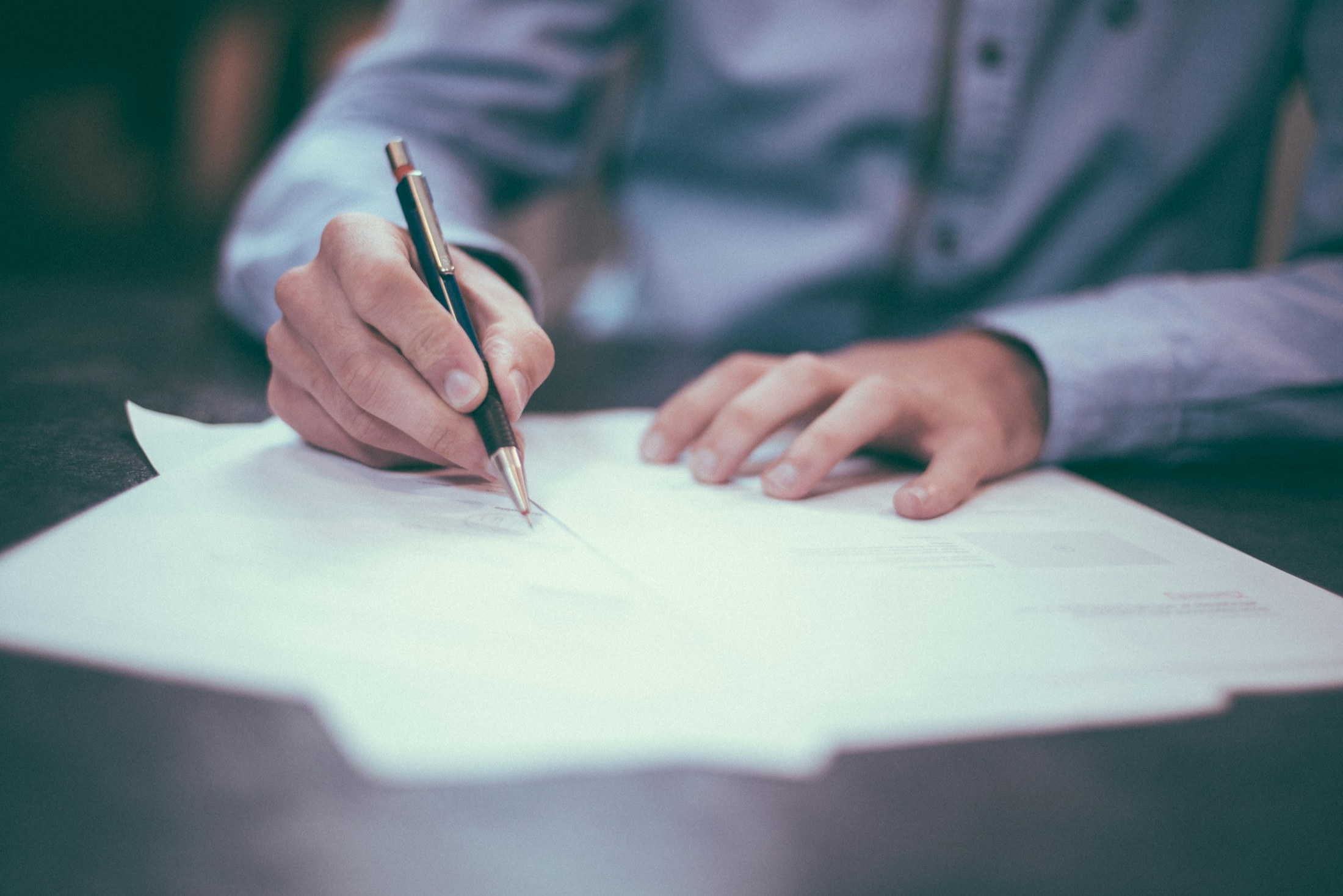 A calculator and pen on a desk — running the numbers before you buy